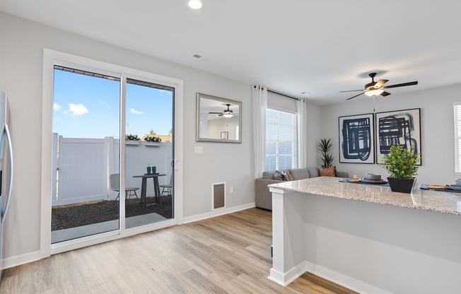 a Sanctuary at Indian Creek rental home living room with large glass sliding doors out to a private back yard 