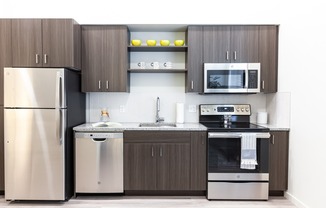 kitchen with stainless steel appliances, granite countertops, and wood-style cabinets