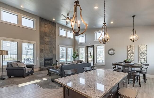 an open concept living room and dining room with a stone fireplace