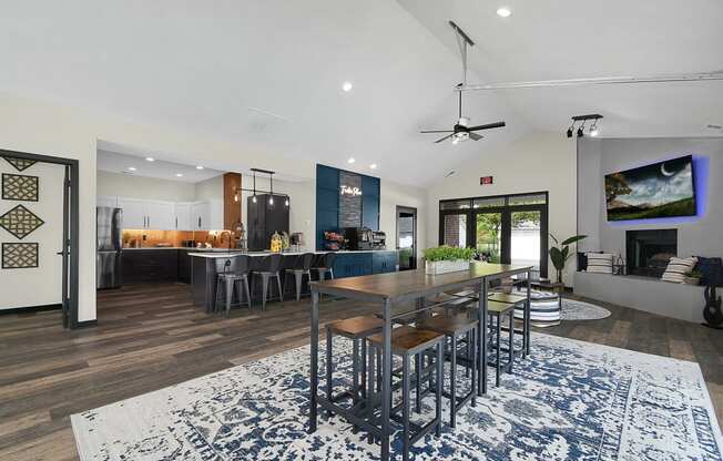 a kitchen and living room with a table and chairs