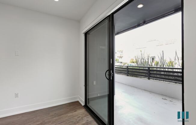 Bedroom with Sliding Glass Doors Leading to the Balcony