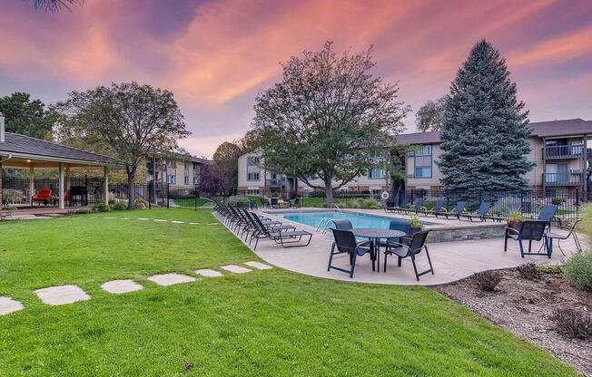 a group of lawn chairs sitting on top of a grass covered park