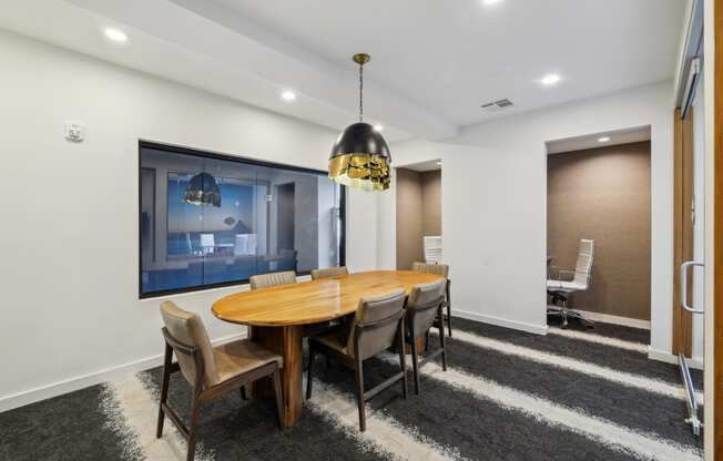 a dining room with a wooden table and chairs at Link Apartments® Broad Ave, Tennessee