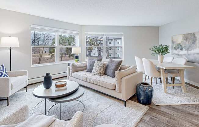 a living room with a couch and chairs and a table