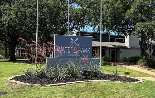 A sign that says Water Park in front of some trees.