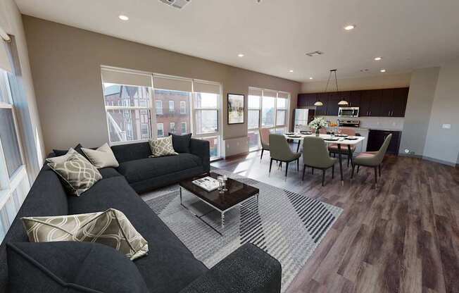 A living room with a black couch and a coffee table.