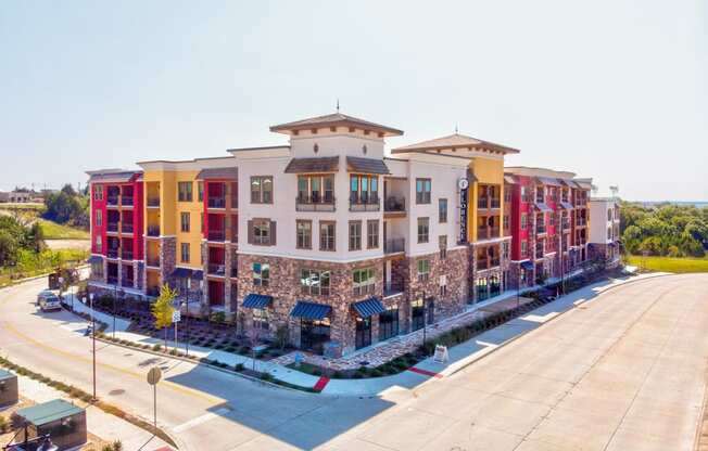 an aerial view of a large apartment complex with a parking lot in front of it