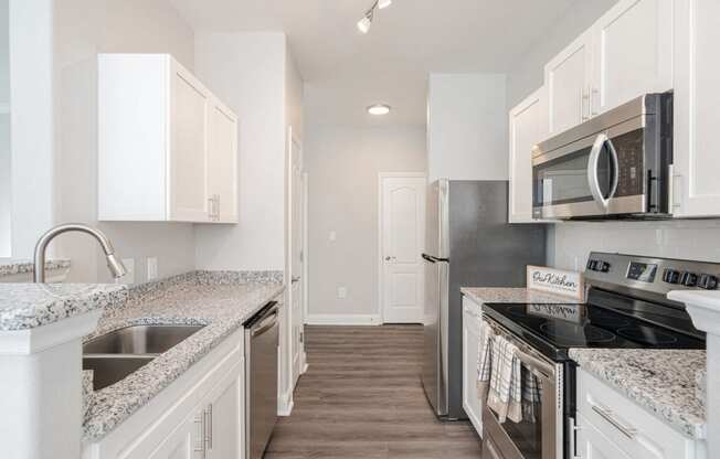 a kitchen with granite counter tops and stainless steel appliances