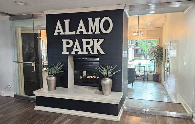 A sign that says Alamo Park is on a black background.