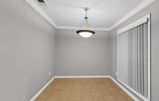 A room with a wooden floor and a ceiling fan.