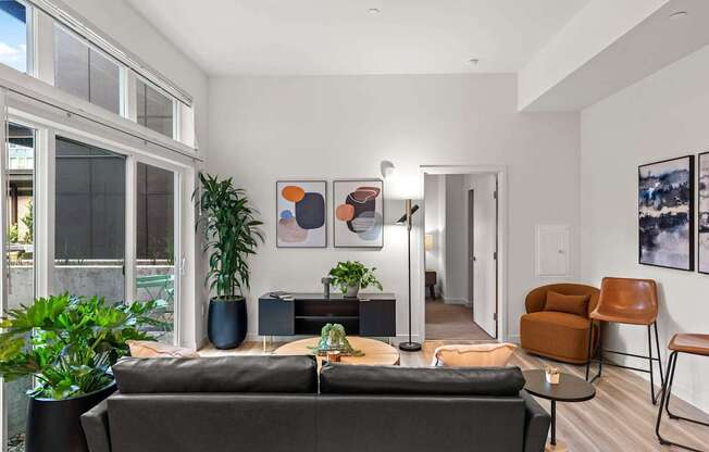 A living room with a grey couch and a brown chair.