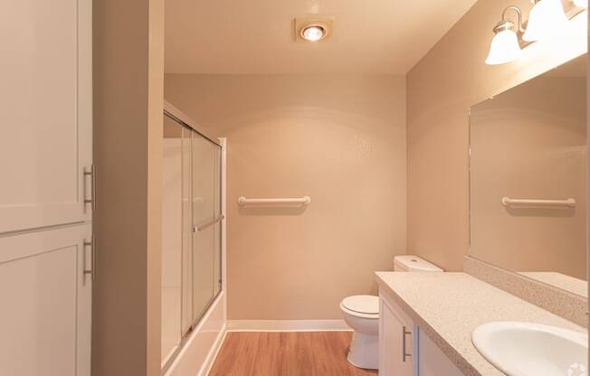 a bathroom with a shower toilet and sink
