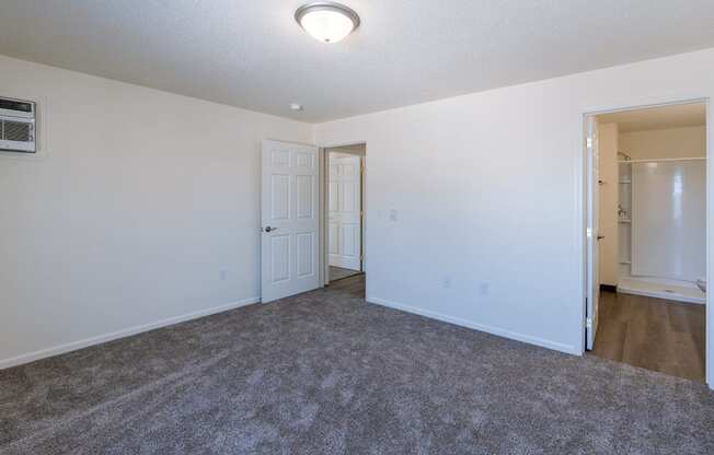 a bedroom with carpet and white walls. Fargo, ND Stonebridge Apartments