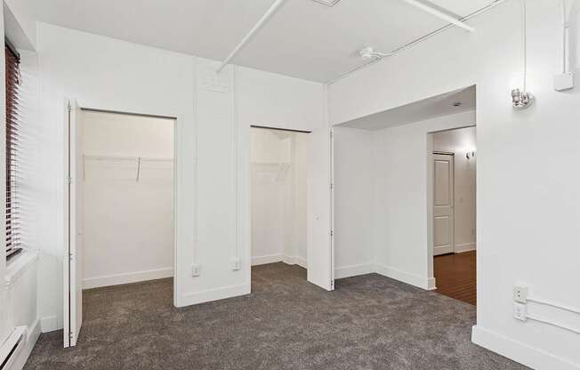 A room with white walls and carpeted floor.