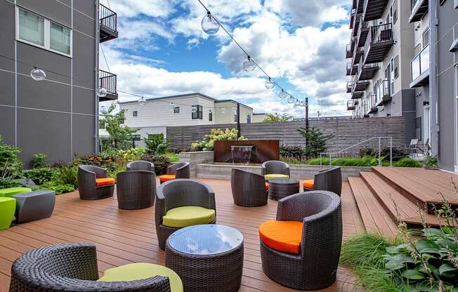 A patio with a lot of chairs and tables.