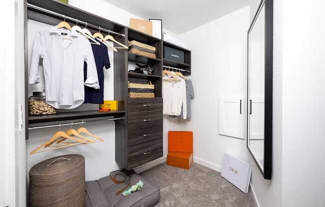 A white shirt is hanging on a hanger in a closet.