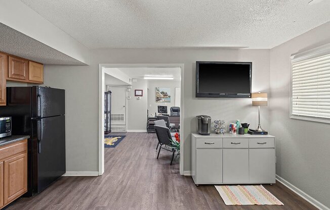 our apartments have a kitchen and living room with a black refrigerator