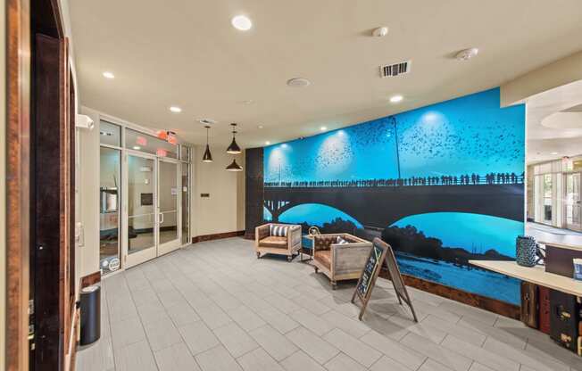 a lobby with a wall mural of a bridge