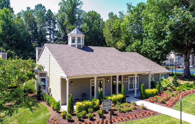 a white building with a cupola and a sign in front of it at Hunters Chase Apartments, Midlothian, VA, 23112