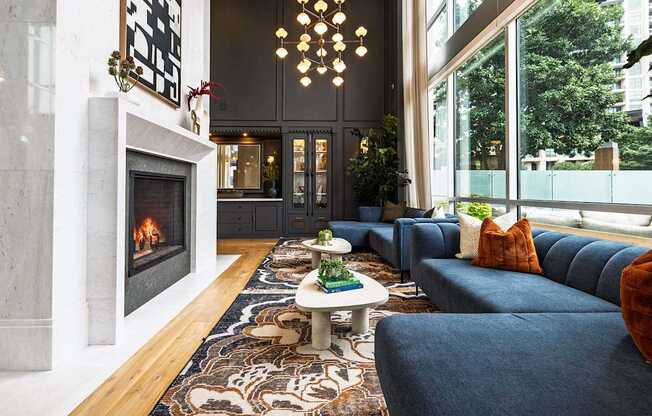 A living room with a fireplace and a blue couch.