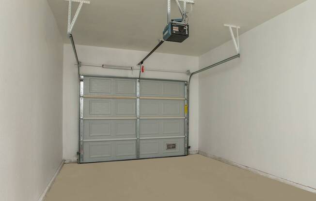 a garage with a garage door and a tv on the ceiling