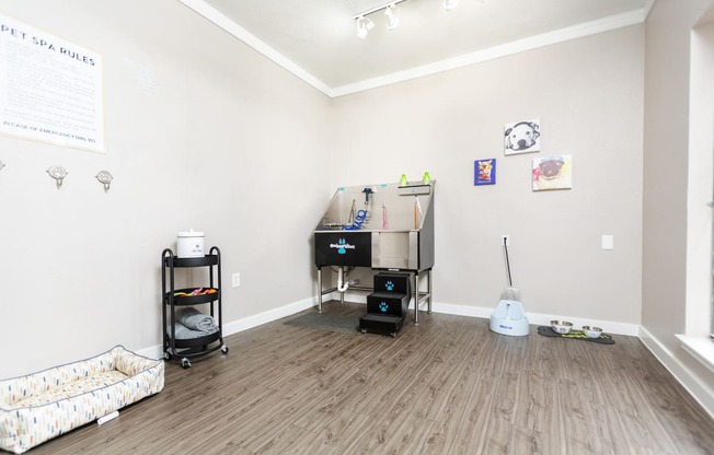 a living room with a couch and a desk in a room with wood flooring