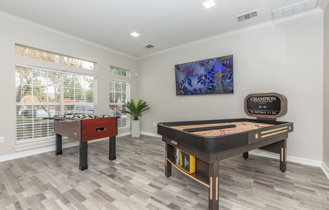 a games room with a foosball table and a ping pong table
