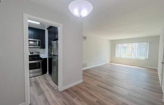 an empty living room and kitchen in a new home