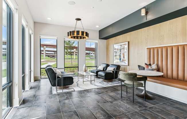 a living room with a table and chairs and a large window