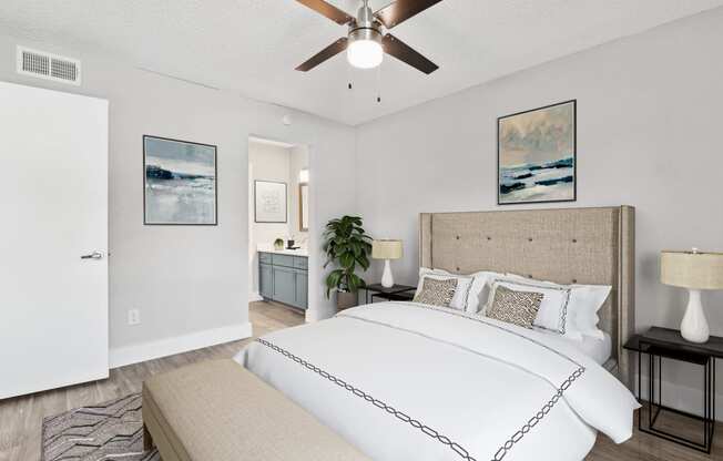 a bedroom with a bed and a ceiling fan