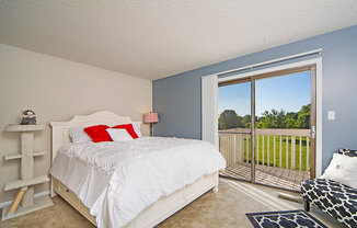 Primary bedroom with Attached Balcony at Indian Woods Apartments in Evansville