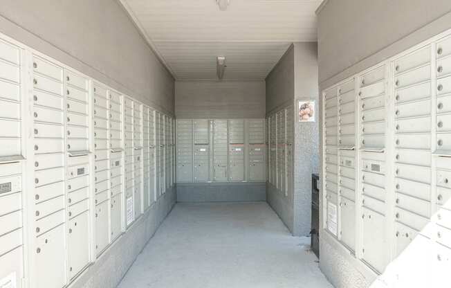 a long hallway with rows of lockers in a building