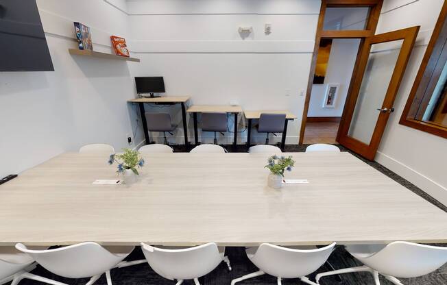 Apt CoWork at The Marq Highland Park's Conference Room Showing Conference Table and Sit-Stand Desks