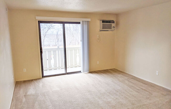 Living Room with Balcony Access at Swiss Valley Apartments, Wyoming, MI