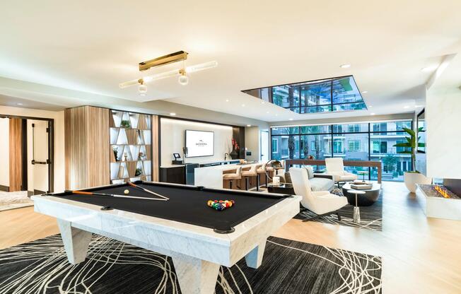 This stylish resident lounge features a striking marble pool table, cozy seating, and fireplace views for a perfect blend of leisure and comfort.
