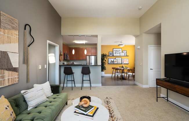 the view from the living room into the kitchen and dining room of an apartment