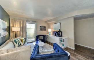 Large Living Room with Window, Hardwood Inspired Floors, White Carpet, Blue Suede Chair, White Sofa, Lamps