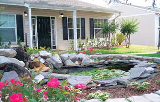 small pond and pink flowers in front of leasing office