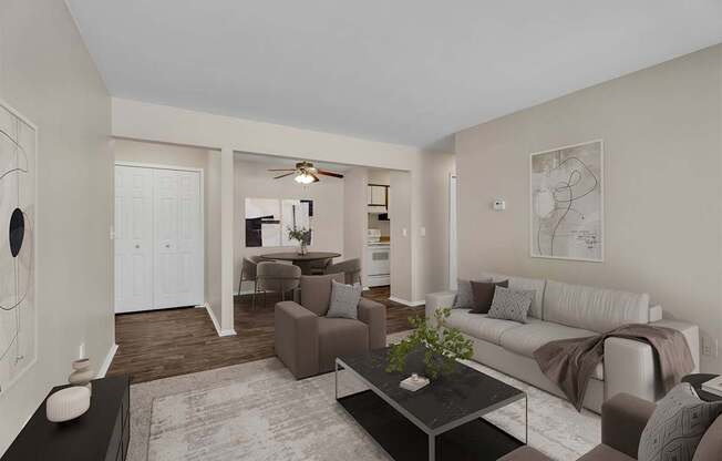 A living room with a couch, chairs, and a coffee table.