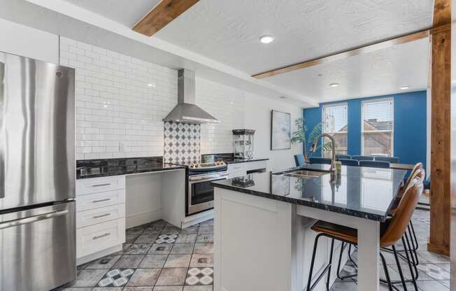 a kitchen with a counter top and a stainless steel refrigerator