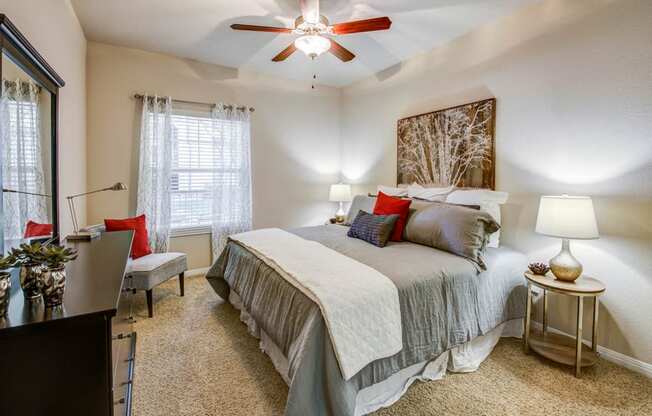 Abelia Flats - Spacious carpeted bedrooms with ceiling fan and natural light