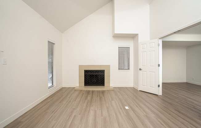 an empty living room with a fireplace