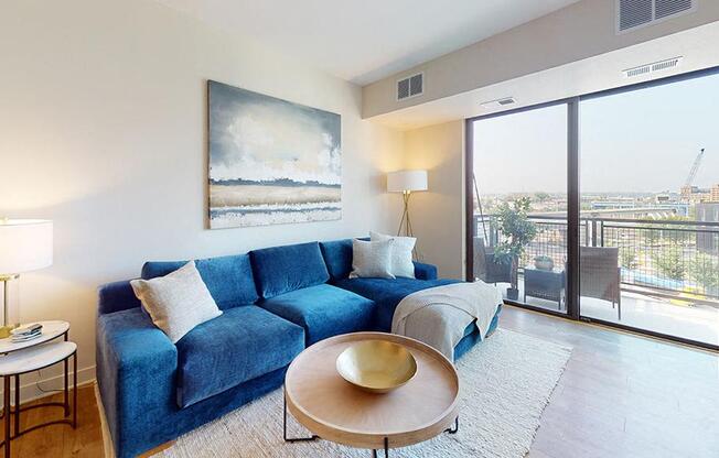 a living room with a blue couch and a table