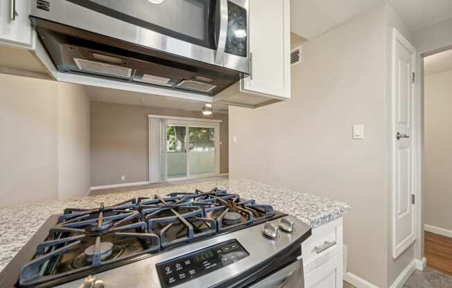 a kitchen with a stove top oven and a microwave