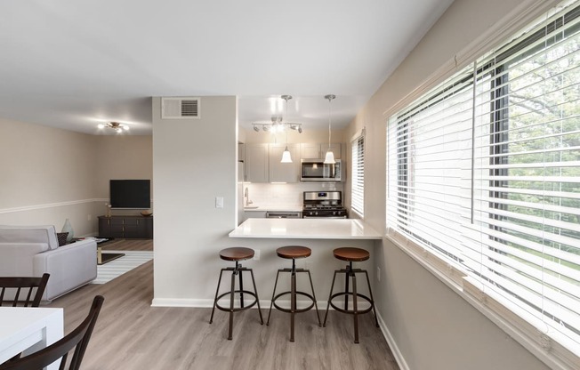 kitchen with a bar and stools at Flats of Forestville, Forestville, Maryland 20747