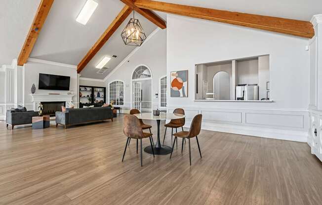 A living room with a black couch and a wooden floor.