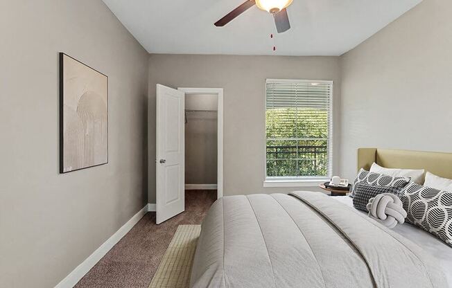 Model Bedroom with Carpet and Walk In Closet at Park West Apartments located in Houston, TX.
