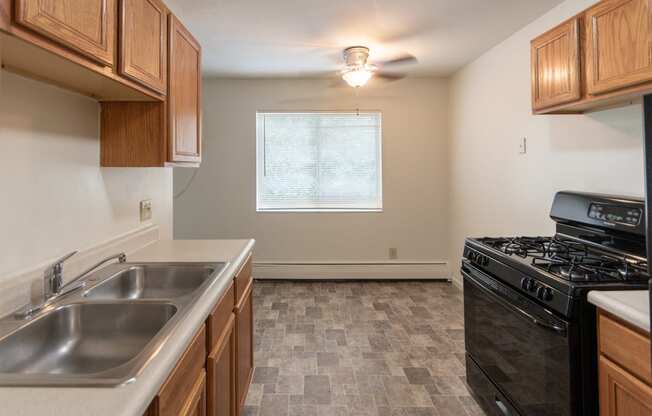 This is a photo of the kitchen and dining room in the 865 square foot, 2 bedroom, 1 and a half bath apartment at Blue Grass Manor Apartments in Erlanger, KY.