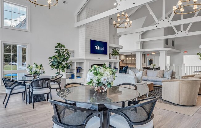 a large living room with a table and chairs