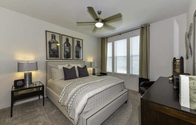 bedroom with large window and ceiling fan